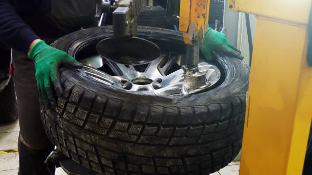istock Tire service. Work on replacing the wheels in the workshop. 1130834859