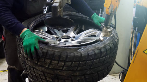 istock Tire service. Work on replacing the wheels in the workshop. 1130834862