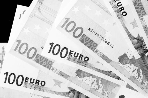 istock One Hundred euro banknotes as a background close up. Black and white 1130835093