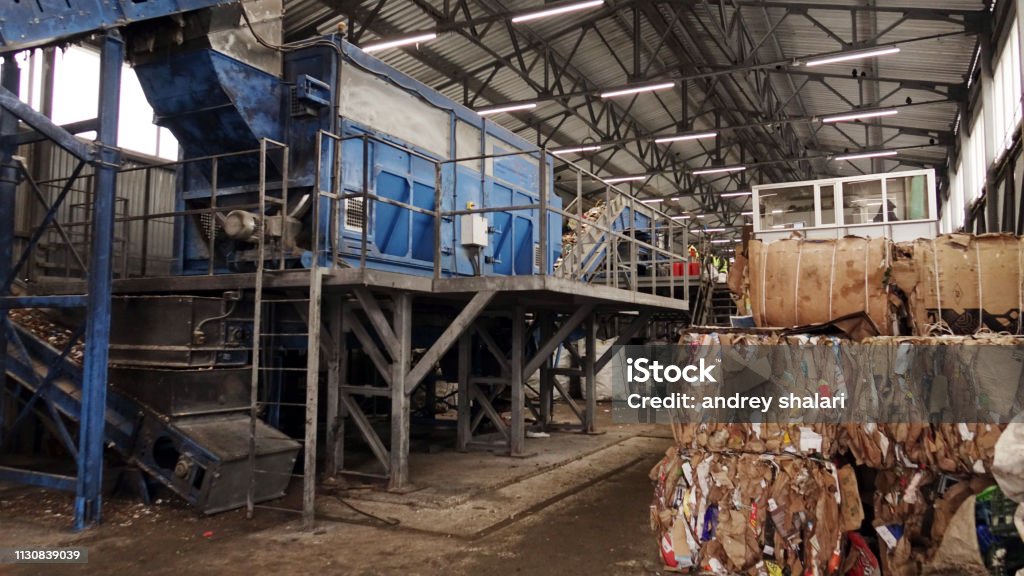 Plastic bales of garbage at the waste processing plant. Processing and storage of waste for further disposal. Plastic bales of garbage at the waste processing plant. Processing and storage of waste for further disposal Backhoe Stock Photo