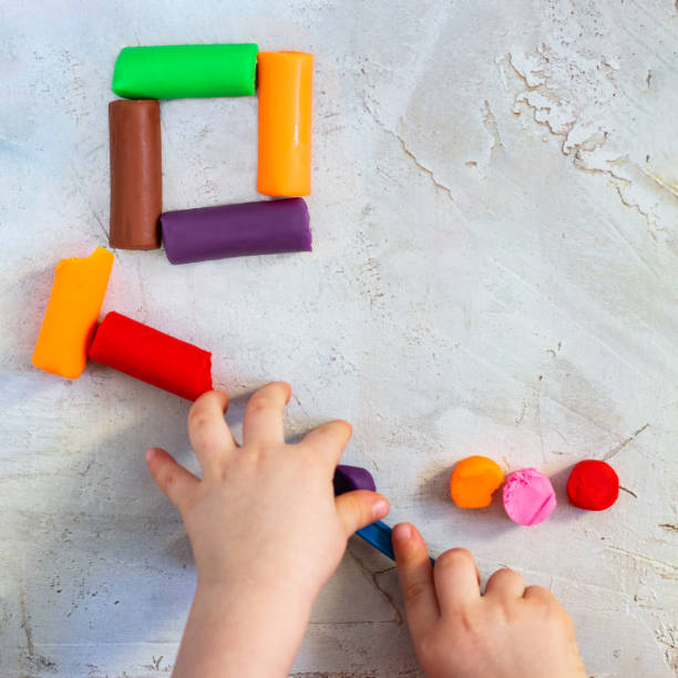 istock Colorful clay plasticine, modelling clay placed like square with child's hands, square, education, child psychology, neuropsychology fine motor skills manual dexterity copy space build mental health 1130845749