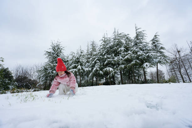 A young girl playing in the snow