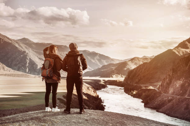 istock Couple travelers looks mountains view 1130849863
