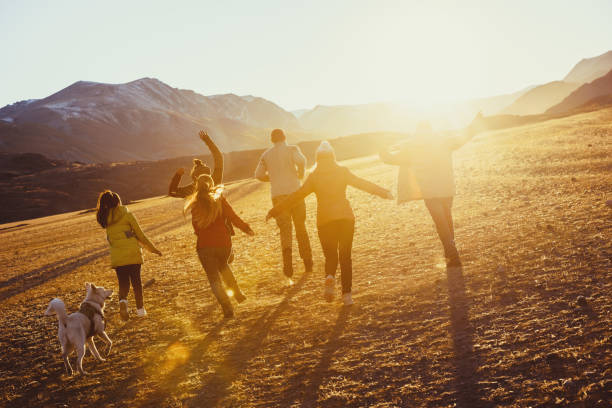 istock Group of happy friends run and jump 1130849880