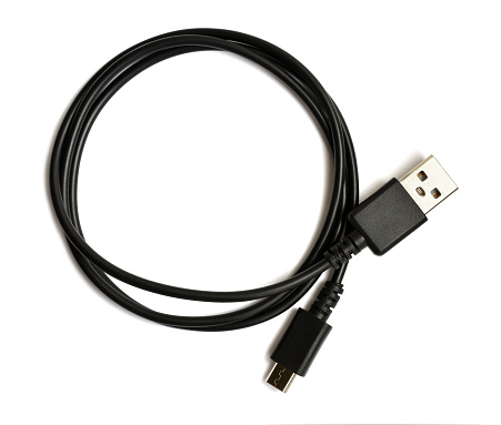 Coiled black USB cable isolated over white background. Top view. There is a usb icon on the plug. USB - micro USB.