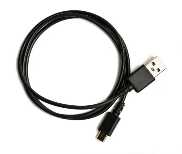Photo of Black USB cable plug isolated on white background. USB - micro USB.