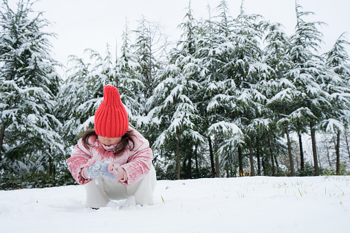 A young girl playing in the snow