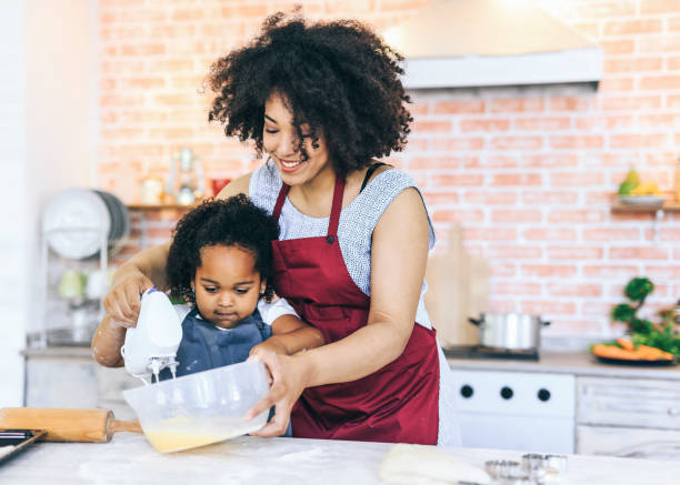istock Mother and child cooking together 1130855411