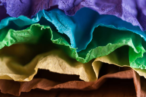 istock Multi-colored crumpled real vivid paper sheets texture background. Close up. Shallow depth of field. 1130856825