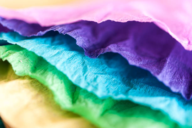 istock Multi-colored crumpled real vivid paper sheets texture background. Close up. Shallow depth of field. 1130856828