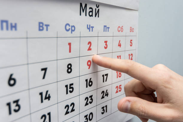 istock Hand points to the May 2 holiday on a wall calendar sheet 1130857558