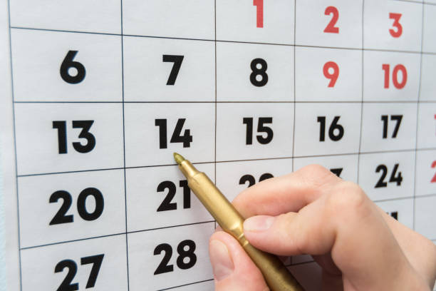 istock Hand marker indicates the date on the wall calendar 1130857559