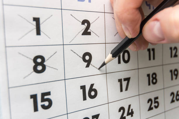 istock Pencil crosses out dates on the wall calendar 1130857564