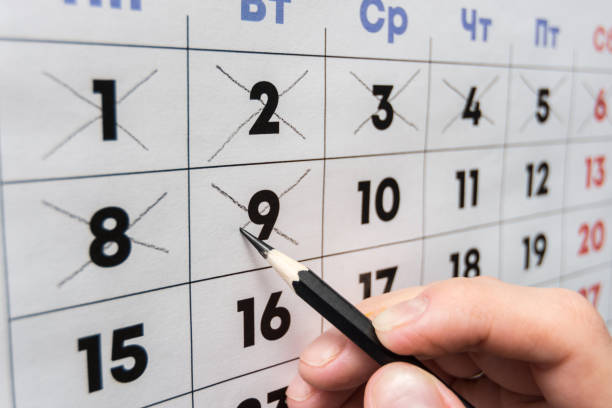 istock Pencil crosses out dates on the wall calendar 1130857565