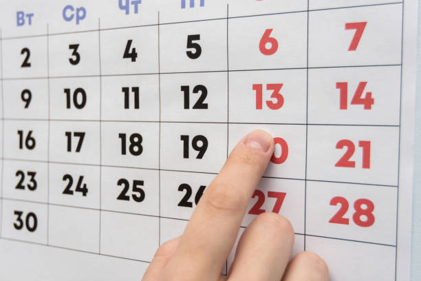 istock Hand pointing to the day off Saturday on a wall calendar 1130857568