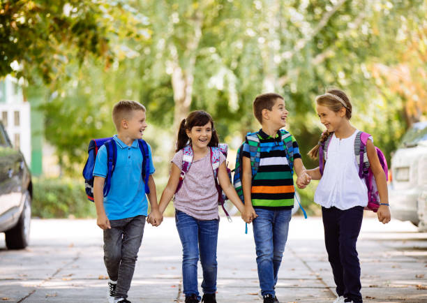 istock School children holding hands and going to school together 1130857753