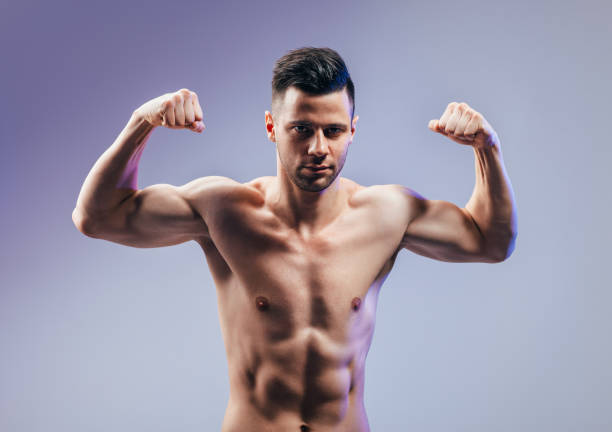 istock Handsome strong bodybuilder athletic man flexing his muscles 1130857993