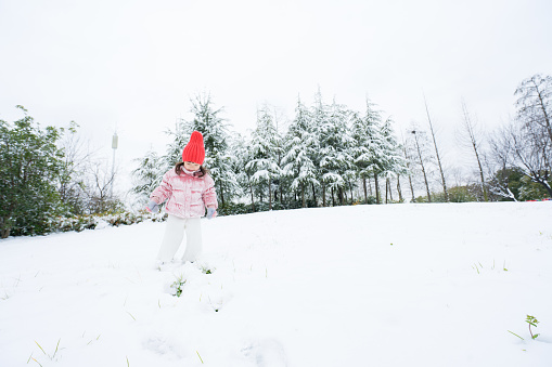 A young girl playing in the snow