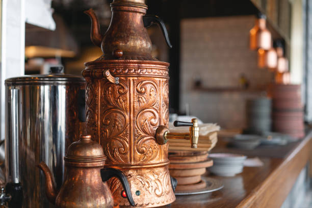 Turkish copper teapot. Drinking traditional Turkish Tea with kettle in cafe.