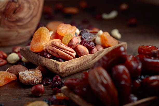istock Various dried fruits and nuts in wooden dish. 1130867253