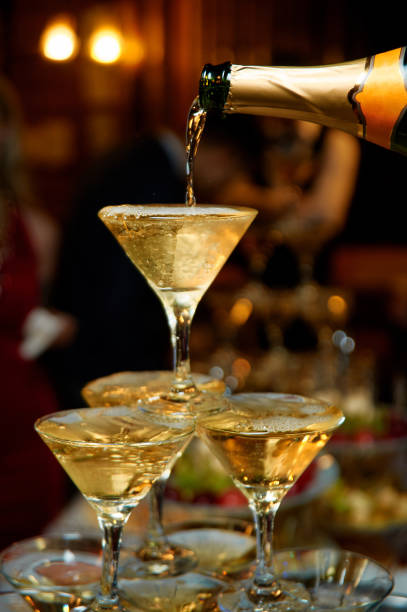 Pouring champagne into champagne flutes on a celebration event