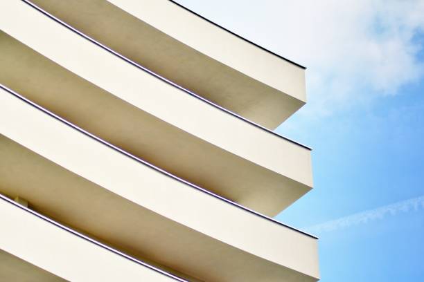 istock Modern white building with balcony on a blue sky 1130867453