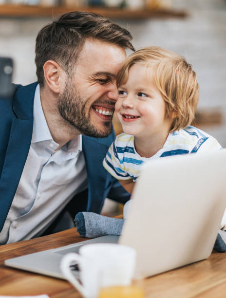 istock Affectionate businessman and his son enjoying at home. 1130867493