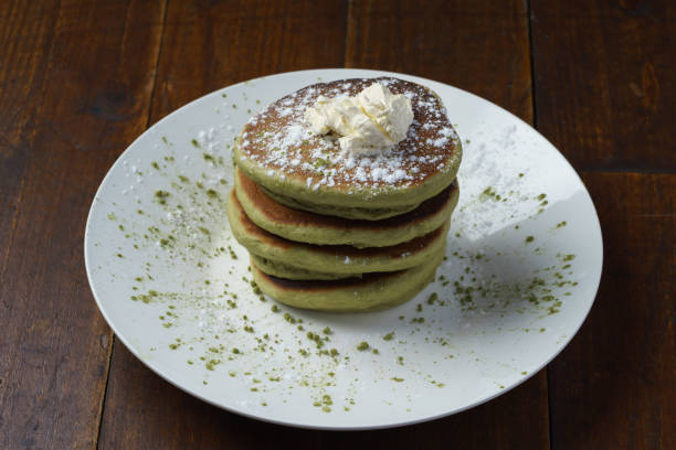 istock green tea pancakes with whipped butter on white plate 1130869798