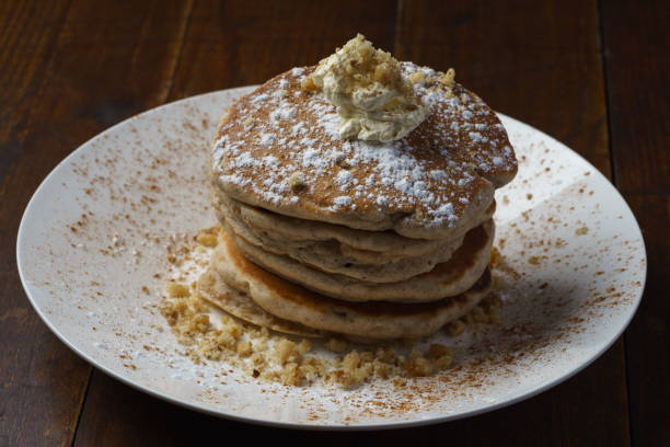 cinnamon walnut American style pancakes cinnamon walnut American style pancakes on white plate on wooden table apple cinnamon pancake stock pictures, royalty-free photos & images