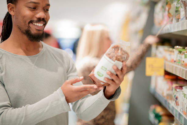 istock Man reading ingredients on organic food package 1130871127