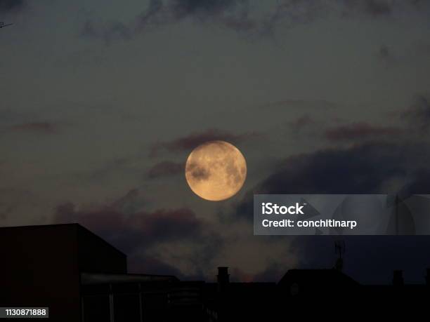 Wolf Moon On The Roofs Of The City Stock Photo - Download Image Now - Full Moon, Astronomy, Beauty In Nature