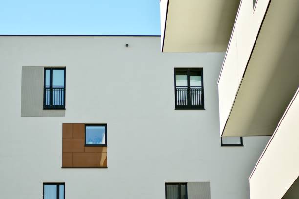 istock Modern white building with balcony on a blue sky 1130871895