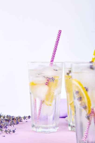 istock Lavender lemonade with lemon and ice on purple background. 1130872194