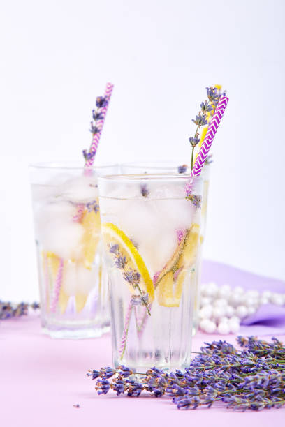 istock Lavender lemonade with lemon and ice on purple background. 1130872201