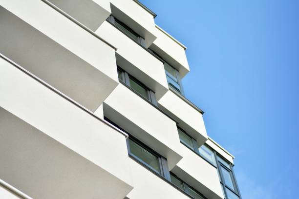 istock Modern white building with balcony on a blue sky 1130872284