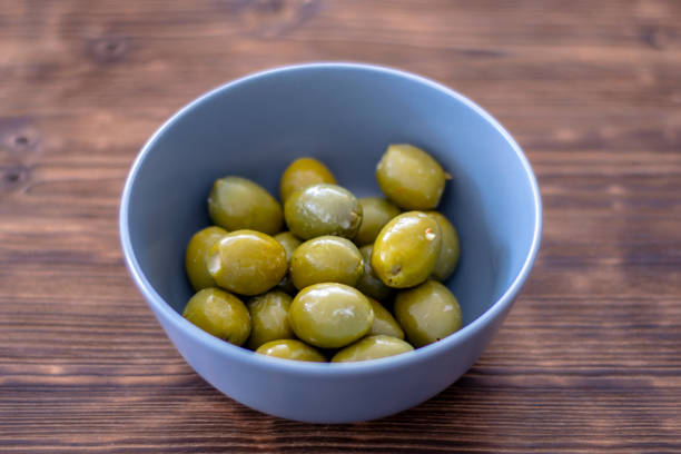 istock Green olives in a bowl 1130873666