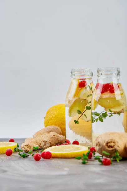 istock Detox water in bottles with cranberrie, ginger, lemon, mint 1130873821