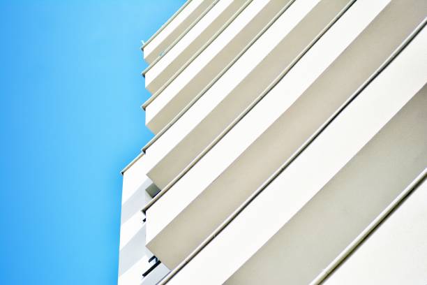 istock Modern white building with balcony on a blue sky 1130876411