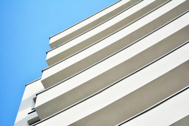 istock Modern white building with balcony on a blue sky 1130876458