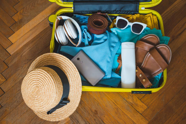istock travel concept. yellow suitcase with different stuff around it 1130876577