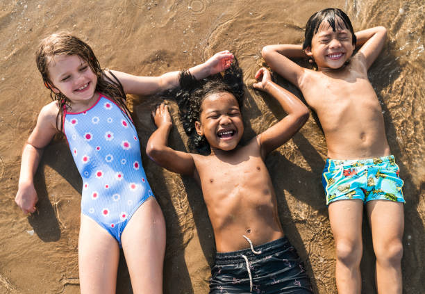 istock Kids having fun on the beach 1130876672
