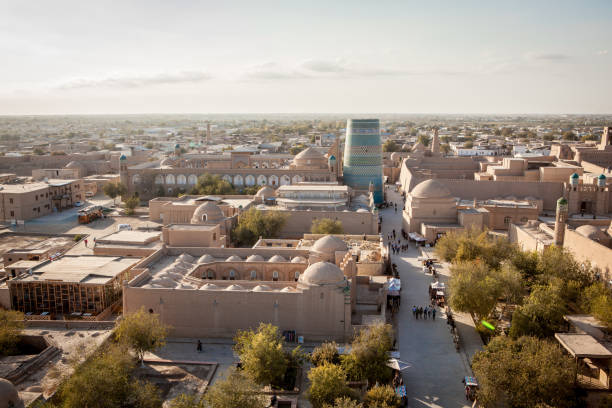 View to Kalta Minor, Itchan Kala View to Kalta Minor, Itchan Kala, the ancient inner city surrounded with walls of Khiva, Khorezm Region, Uzbekitan. Small stone houses, museums and minaretes khiva stock pictures, royalty-free photos & images