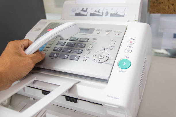 istock hand man are using a fax machine in the office 1130878230