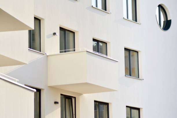 istock Modern white building with balcony on a blue sky 1130879408