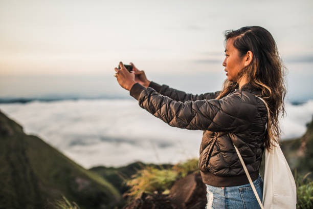 istock Woman photographing nature 1130879636