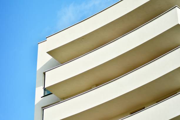 istock Modern white building with balcony on a blue sky 1130880190