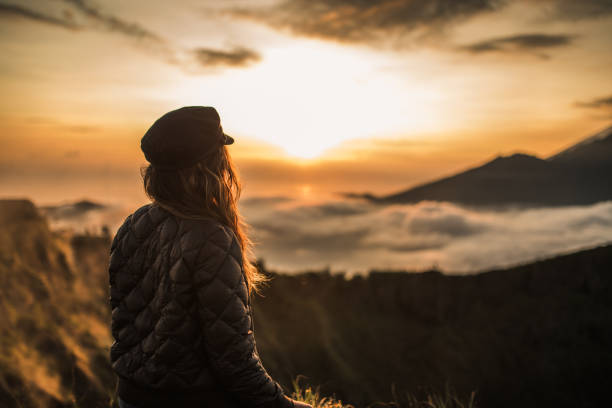 istock Woman enjoying in amazing sunset on mountain 1130880802
