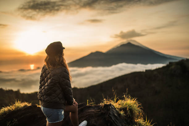 istock Woman enjoying in amazing sunset 1130880827