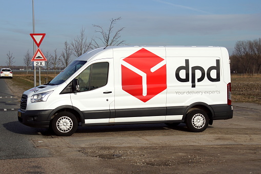 Almere Poort, the Netherlands - February 20, 2019: DPD delivery van parked by the side of the road. Nobody in the vehicle.