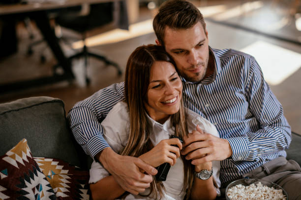 istock Young couple with popcorn looking movie 1130886422